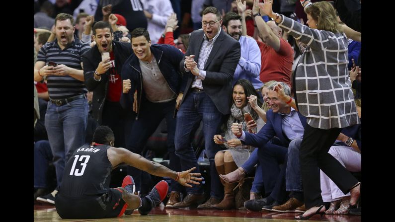 Courtside fans cheer on Houston's James Harden after he was fouled on a 3-point shot on Tuesday, January 30. The Rockets star became <a target="_blank" target="_blank">the first person in NBA history</a> to score 60 points and record a triple-double in the same game.