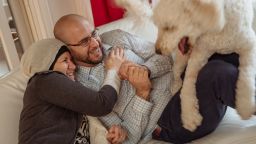 Layla Barakat, left, and her son, Farris Barakat and dog, AJ, hang out on the couch at the Barakat household in Raleigh, North Carolina on Wednesday, December, 20, 2017. Three years ago, Layla's son, Deah Barakat was murdered in his home along with his wife and wife's sister.Mike Belleme for CNN