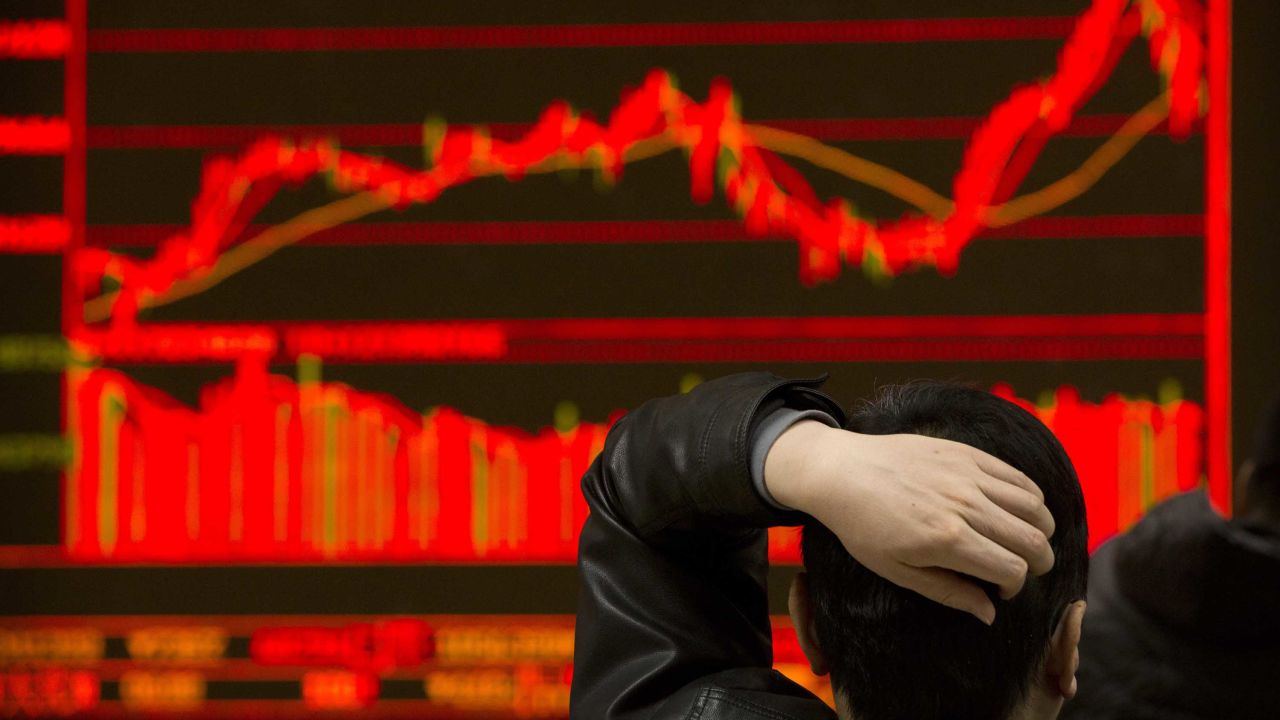 An investor monitors stock prices at a brokerage house in Beijing, Tuesday, Feb. 6, 2018. Shares tumbled in Asia on Tuesday after a wild day for U.S. markets that resulted in the biggest drop in the Dow Jones industrial average in six and a half years. (AP Photo/Mark Schiefelbein)