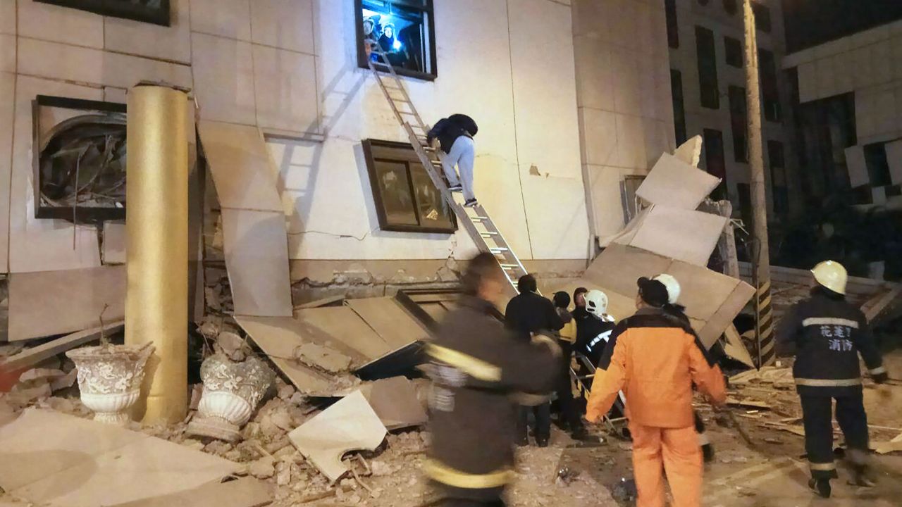 Emergency responders carry out search-and-rescue operations amid rubble outside the Marshal Hotel.