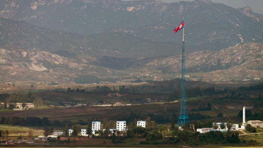 A North Korean flag flutters over North Korea's village of Gijungdong as seen from an observatory point in Paju near the Demilitarized Zone (DMZ) dividing the two Koreas on September 25, 2013. The 250-kilometre (155-mile) long Demilitarised Zone dividing the two neighbours is a depopulated no-man's land bristling with landmines and listening posts.   AFP PHOTO / KIM DOO-HO        (Photo credit should read KIM DOO-HO/AFP/Getty Images)
