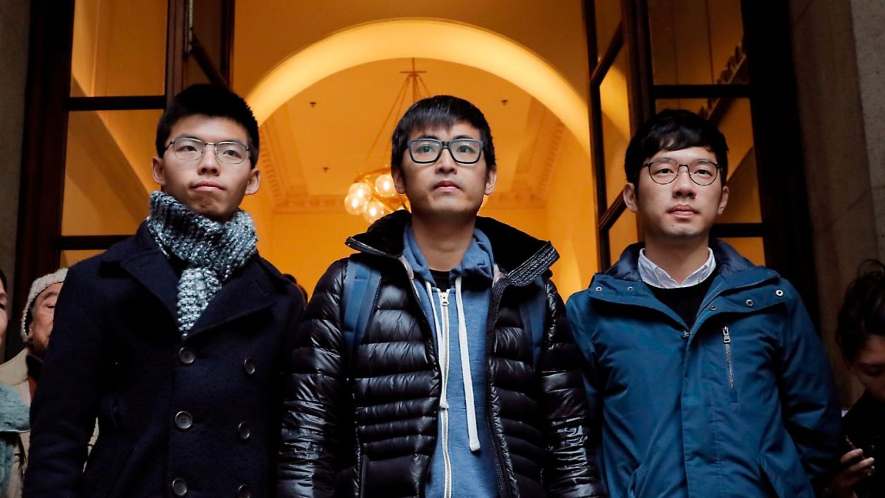 Pro-democracy activists Joshua Wong, Alex Chow and Nathan Law, walk out from the Court of Final Appeal in Hong Kong on February 6, 2018.