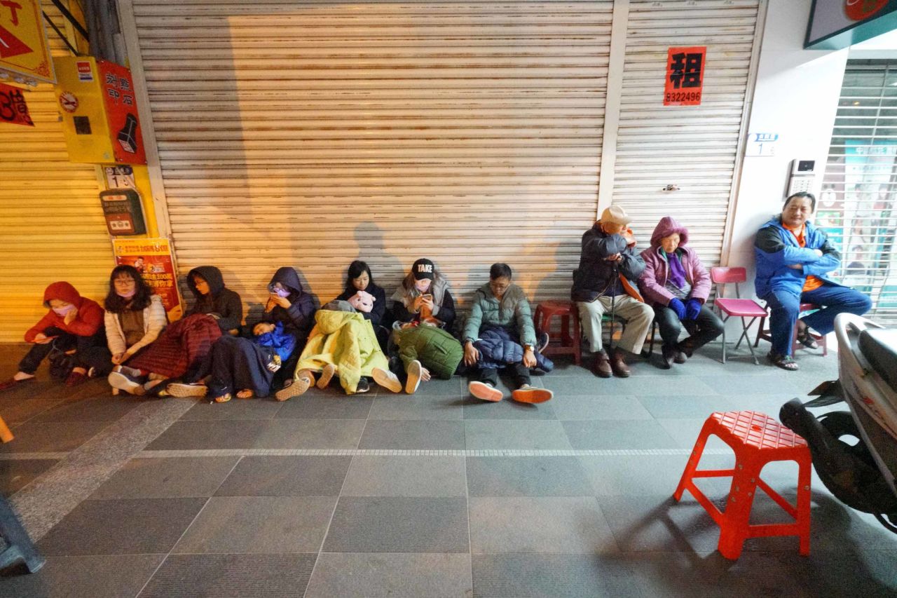 Guests of the quake-damaged Marshal Hotel take refuge outside on February 7.