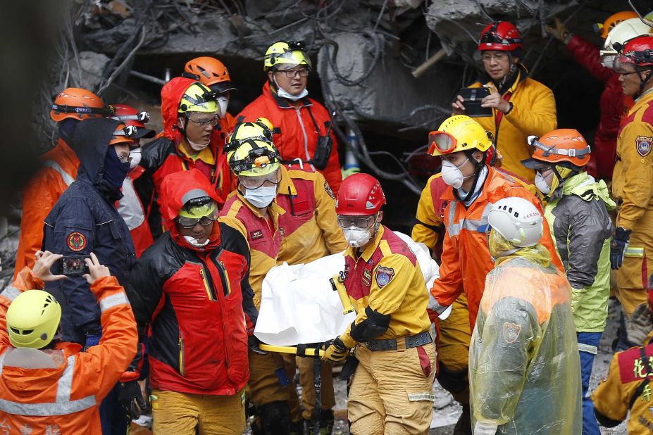 Emergency workers recover a victim from a destroyed building in Hualien on February 7.