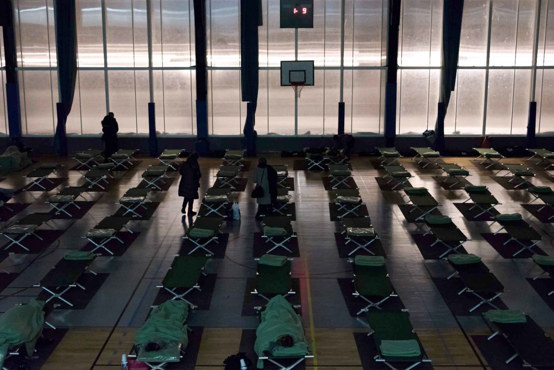 People stranded by the snow rest in an emergency shelter installed at the Robert Wagner gymnasium in Velizy-Villacoublay, southwestern suburbs of Paris.