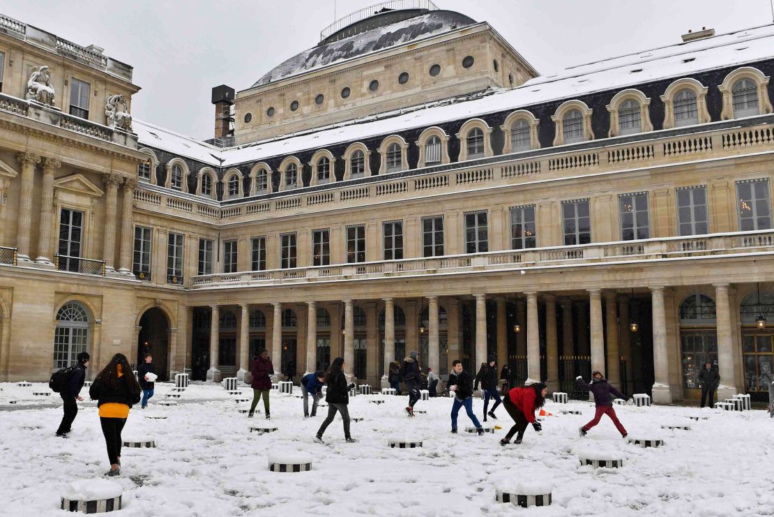 Children play in the snow in the Palais Royal garden on Wednesday.