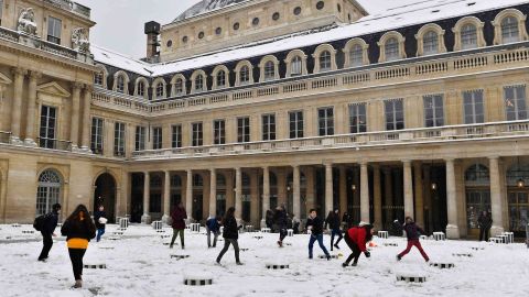 Children play in the snow in the Palais Royal garden on Wednesday.