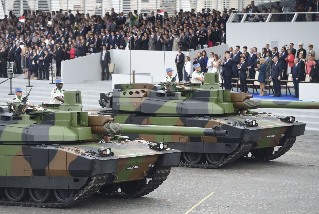 Tanks parade past guests including US President Donald Trump on Bastille Day, 2017. 