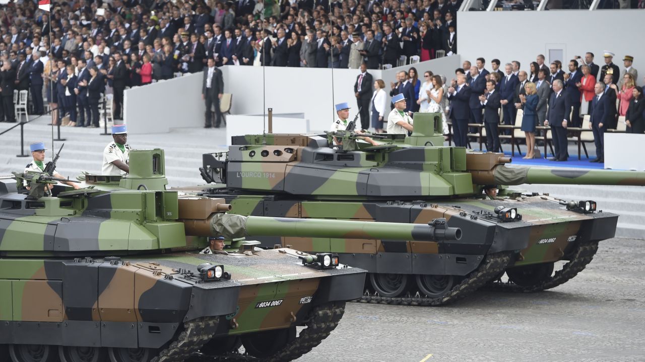 Tanks parade past guests including US President Donald Trump on Bastille Day, 2017.
