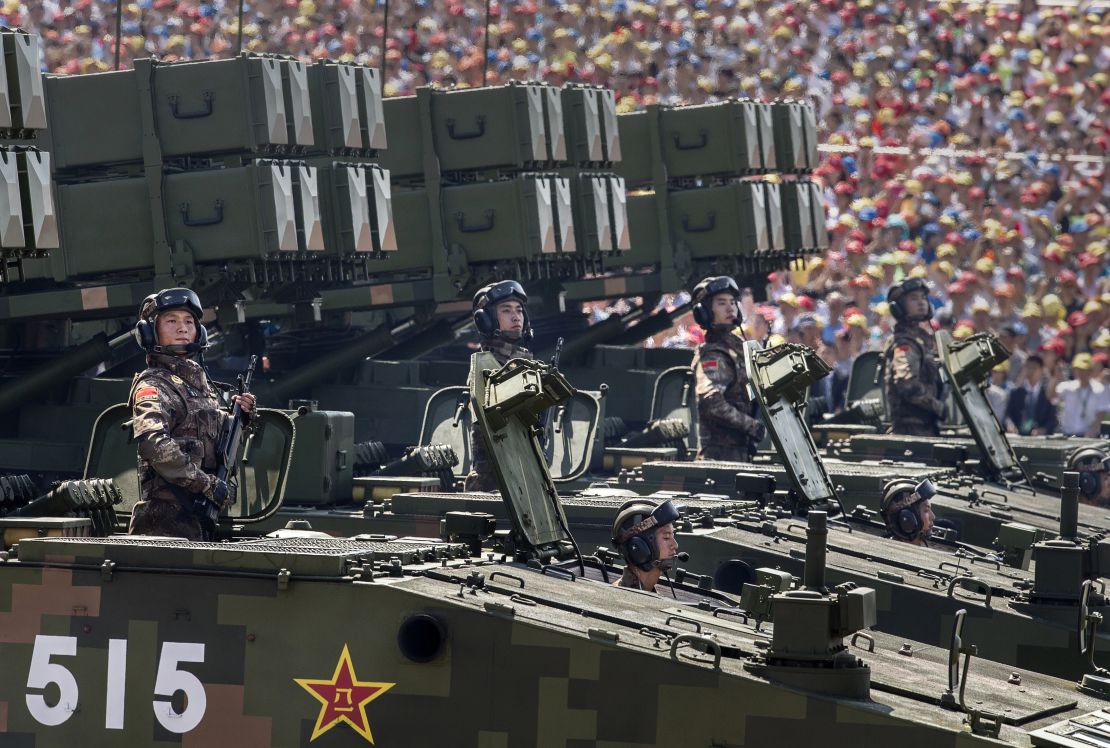Chinese soldiers ride on armored missile carriers as they pass in front of Tiananmen Square and the Forbidden City during a military parade on September 3, 2015, in Beijing.