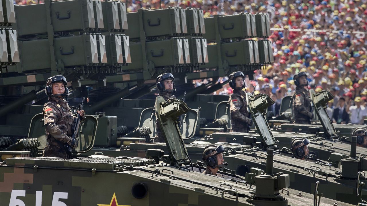 Chinese soldiers ride on armored missile carriers as they pass in front of Tiananmen Square and the Forbidden City during a military parade on September 3, 2015, in Beijing.