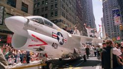A Navy A-7 Corsair jet is pulled down Broadway Avenue as sailors rejoice on the wings during the Operation Welcome Home ticker-tape  parade during the 10 June 1991 celebration for returning Gulf War troops.  An estimated 1 million people came to welcome some 24,000 Desert Storm veterans.       AFP PHOTO DON EMMERT        (Photo credit should read DON EMMERT/AFP/Getty Images)