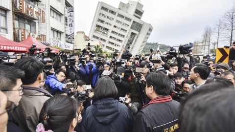 Taiwanese President Tsai Ing-wen, center, is briefed at the site of a collapsed building Wednesday.