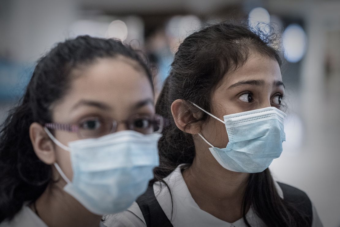 Hong Kong school children wearing face masks. The city has ordered the early holiday closure of some schools to prevent the spread of influenza.