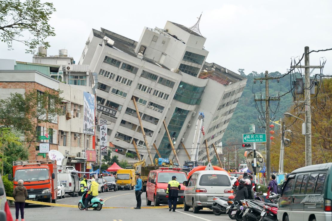 Emergency workers block off a street in Hualien, Taiwan, where a building threatens to collapse.