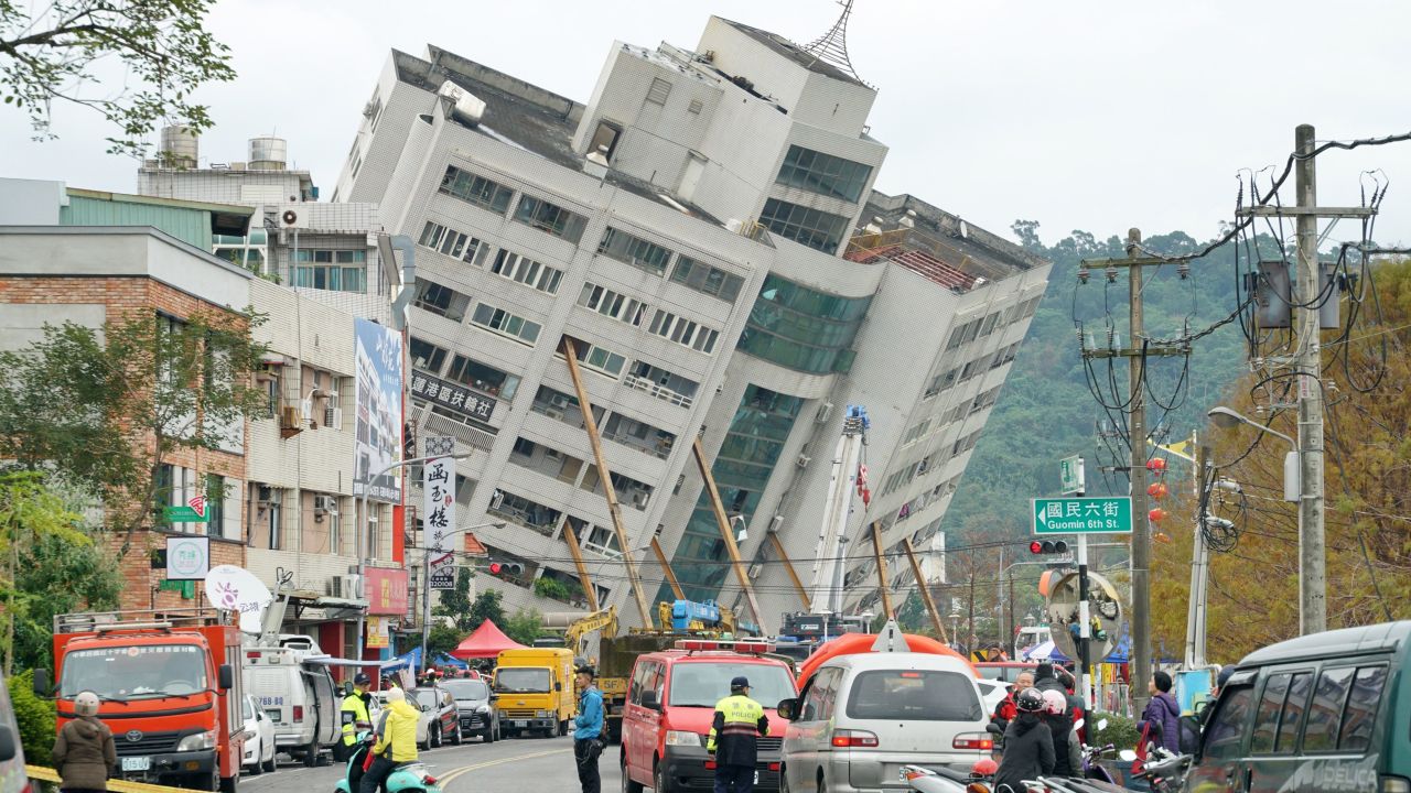 Emergency workers block off a street in Hualien, Taiwan, where a building threatens to collapse.