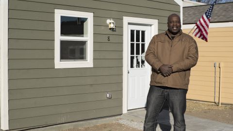 Marvin Gregory, a veteran of the US Army and Coast Guard stands in front of his new home.