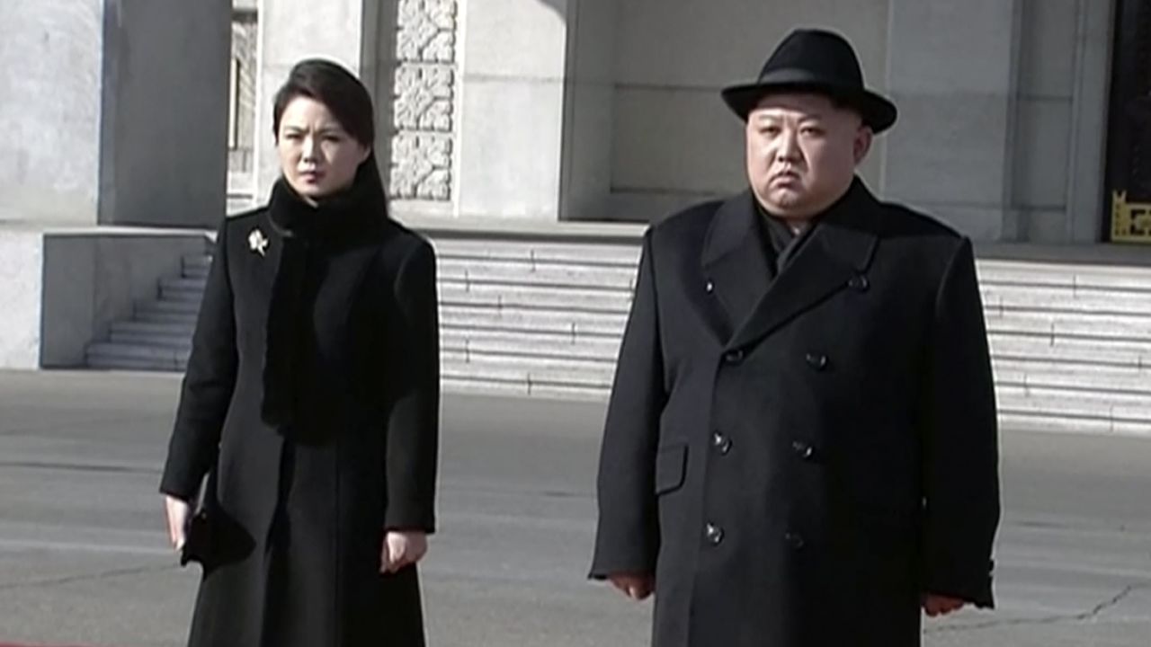 North Korean leader Kim Jong Un, right, and his wife Ri Sol Ju arrive at the parade