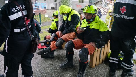 Rescuers rest near the site of damaged buildings in Hualien on February 8.