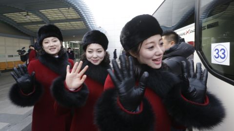 North Korean cheering squads wave upon arriving at the Korean-transit office near the Demilitarized Zone that divides the two Koreas Thursday.