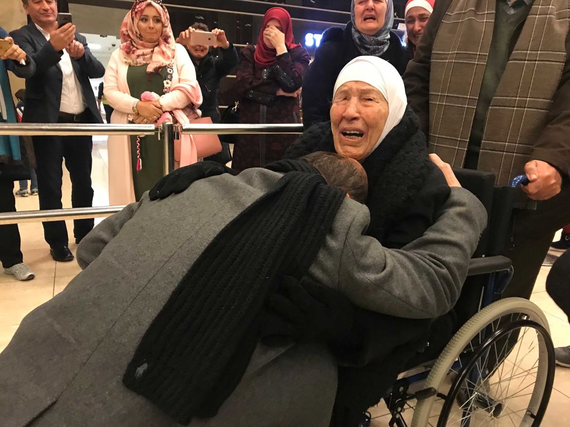 Amer Adi falls to his knees as he reunites with his mother for the first time in 20 years.