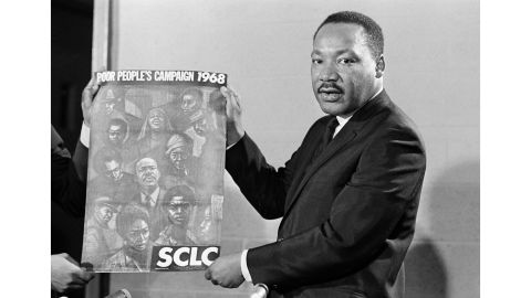 Dr. Martin Luther King displays the poster to be used during his Poor People's Campaign, March 4, 1968, one month before he was shot to death by a sniper.  