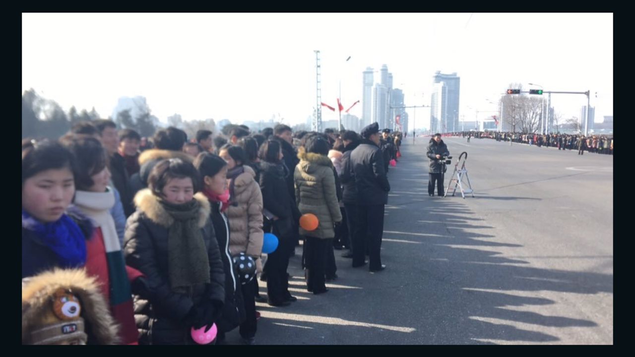 Bystanders wait for the parade to begin in Pyongyang, North Korea. 