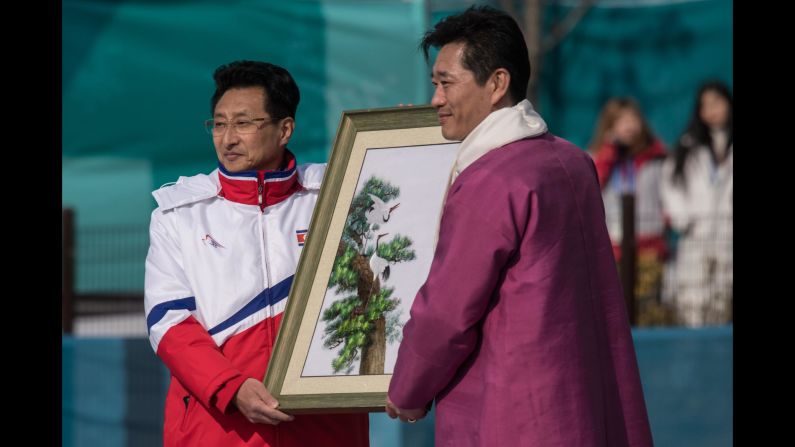 North Korea's Won Kil U offers a gift during a welcoming ceremony for North Korea's athletes.