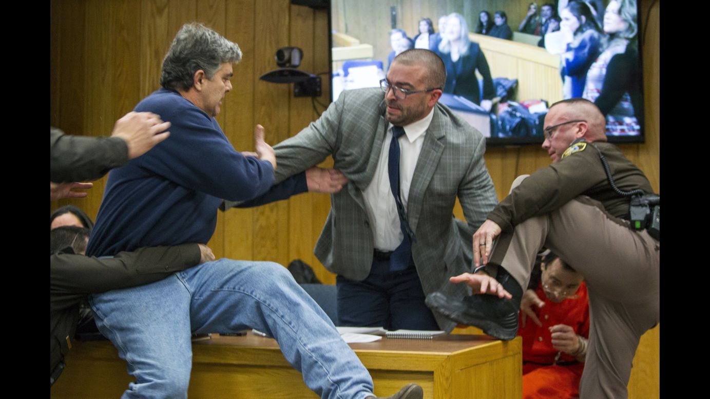 Randall Margraves, left, <a href="http://www.cnn.com/2018/02/02/us/larry-nassar-attack-court/index.html" target="_blank">lunges at Larry Nassar</a>, bottom right, during Nassar's third and final sentencing hearing in Charlotte, Michigan, on Friday, February 2. Margraves, the father of three daughters who say they were abused by Nassar, tried to attack Nassar -- the former doctor for USA Gymnastics and Michigan State University -- in an Eaton County, Michigan, courtroom before Margraves was tackled and detained by security. Margraves was brought back into the court in handcuffs during a lunch break, and he apologized to the court.