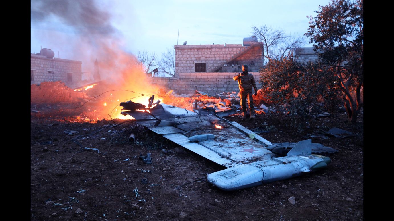A rebel fighter takes a picture of a downed Russian Su-25 warplane in Syria's northwest province of Idlib on Saturday, February 3. <a href="http://www.cnn.com/2018/02/03/middleeast/russian-plane-shot-down-syria/index.html" target="_blank">Militants shot down the plane</a> in an area controlled by al-Nusra Front fighters, according to a RIA Novosti report. The Russian defense ministry said the pilot was able to eject from the aircraft before it crashed, according to state-run news agency TASS, but died while fighting al-Nusra fighters.