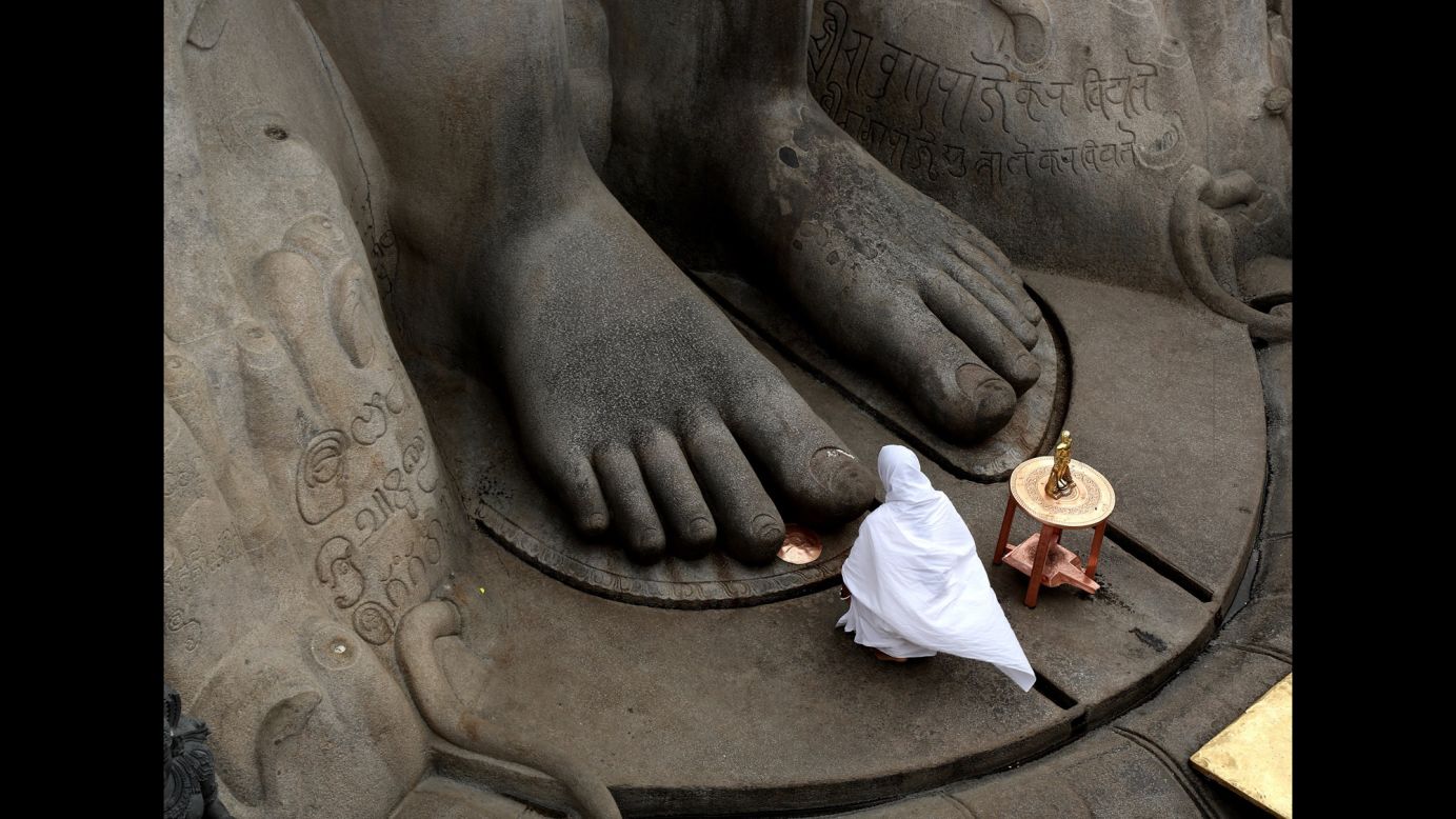 A Jain nun offers prayers at the statue of Lord Bahubali during the <a href="http://mahamasthakabhisheka.com/" target="_blank" target="_blank">88th Bahubali Mahamasthakabhisheka Mahotsava ceremony</a> in Shravanabelagola, India, on Wednesday, February 7. The town  will attract millions of people from across the country for the head-anointing ceremony of the 57-foot-tall statue. The Jain ritual will run from February 7 to 26 and is held once every 12 years.