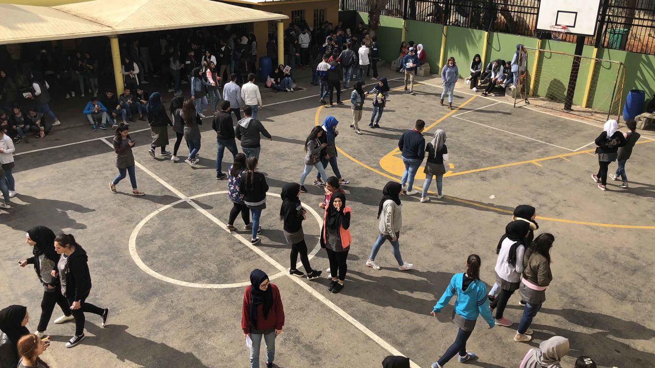 Students spend their recess at the school's basketball court. 