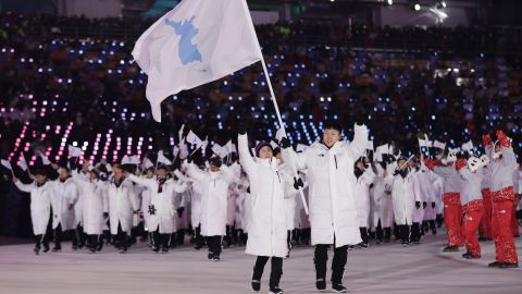 North Korea's Hwang Chung Gum and South Korea's Won Yun-jong arrive during the opening ceremony.