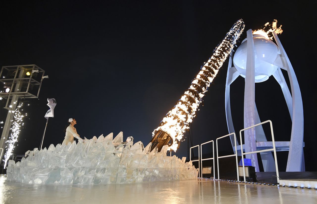 Former figure skater Kim Yuna lights the Olympic cauldron. The South Korean won gold in the 2010 Winter Olympics.
