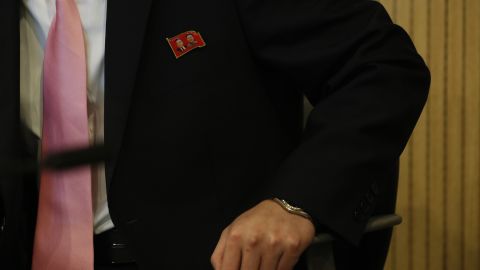 A North Korean operator wearing a badge with the portraits of late North Korean leaders Kim Il-sung and Kim Jong-il works while North Korea's Samjiyon Orchestra performs on February 8, in Gangneung, South Korea.