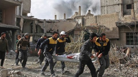 White Helmets rescuers evacuate a victim of an airstrike Thursday in the rebel-held enclave of Hazeh.