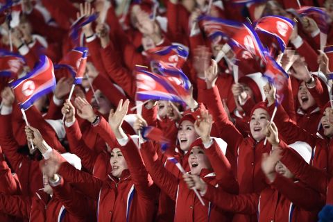 North Korean cheerleaders wave their country's flag as they gather ahead of the opening ceremony.
