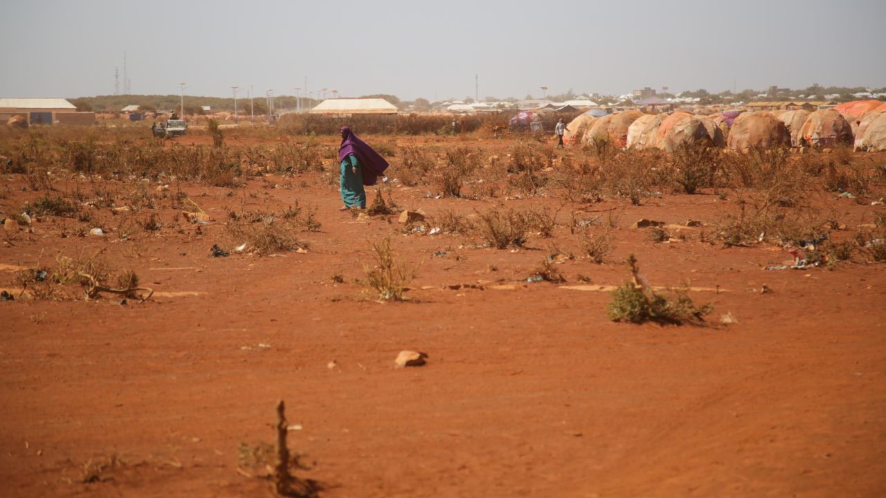 An internally displaced woman walks near a refugee camp in Baidoa.