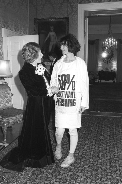 Prime Minister Margaret Thatcher greets fashion designer Katharine Hamnett, who's wearing a T-shirt with a nuclear missile protest message, in March 1984 at 10 Downing Street, during a reception for British Fashion Week designers.