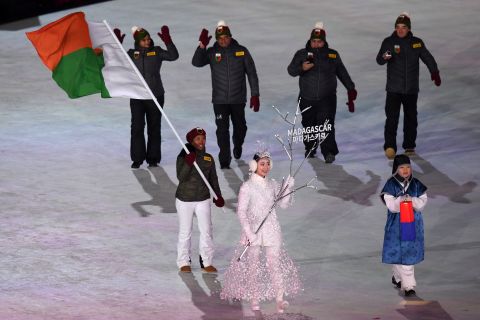 Flag bearer Mialitiana Clerc of Madagascar leads the team at the opening ceremony. She was born in Madagascar but learnt to ski in France and is the first woman to compete for the country in alpine skiing.