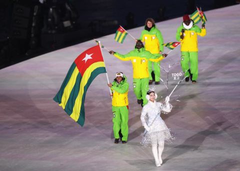 Flag bearer Mathilde-Amivi Petitjean of Togo is accompanied by her team. The second athlete for Togo Alessia Afi Dipol is an Italian alpine skier.