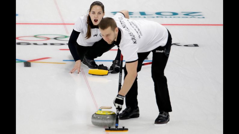 Olympic Athlete from Russia Anastasia Bryzgalova makes a call to her teammate Aleksandr Krushelnitckii during a mixed curling match against South Korea's Jang Hyeji and Lee Kijeong.