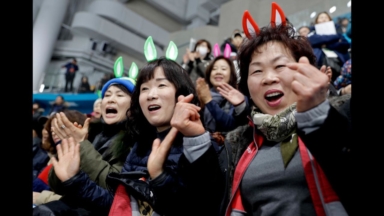 South Korean fans cheer their team during a mixed curling match against Olympic Athletes from Russia.