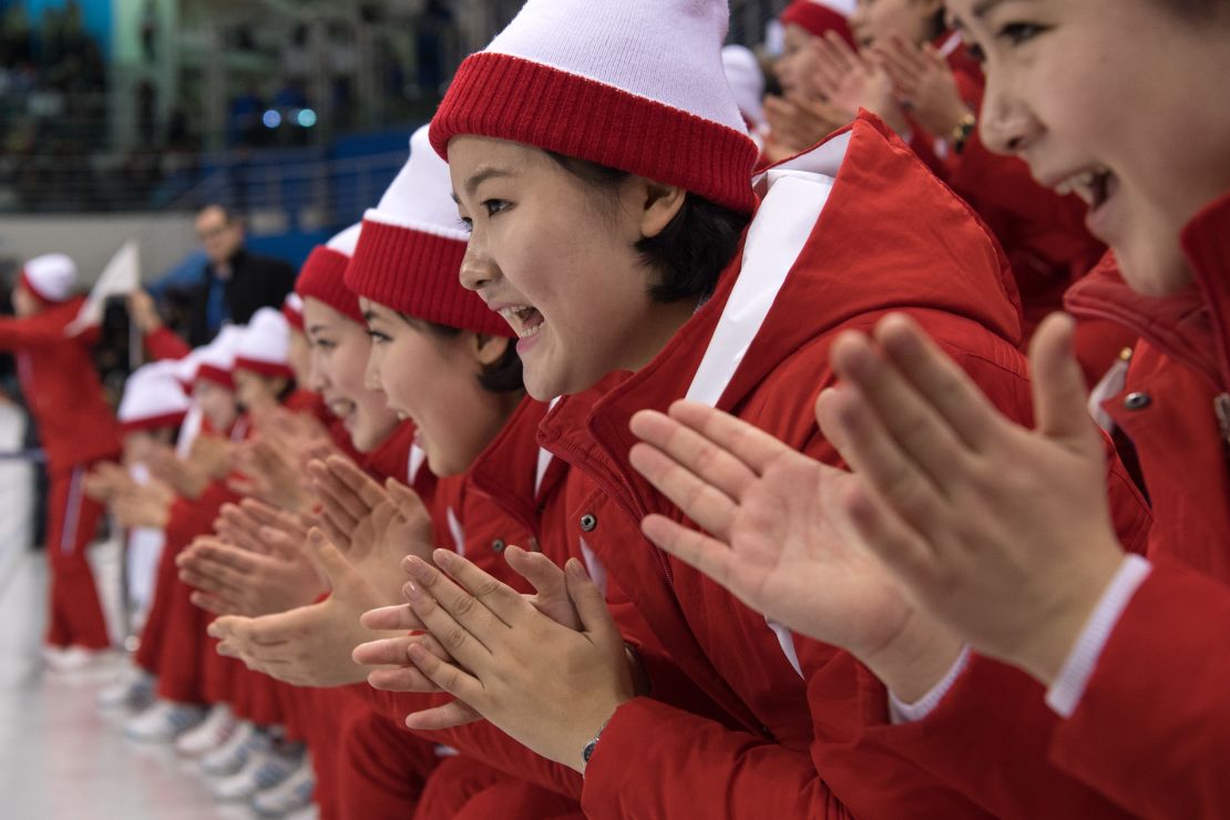 North Korean cheerleaders clap enthusiastically during the unified team's ice hockey match against Switzerland.