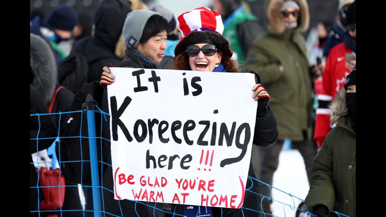 A spectator holds a sign at the men's snowboarding slopestyle final.