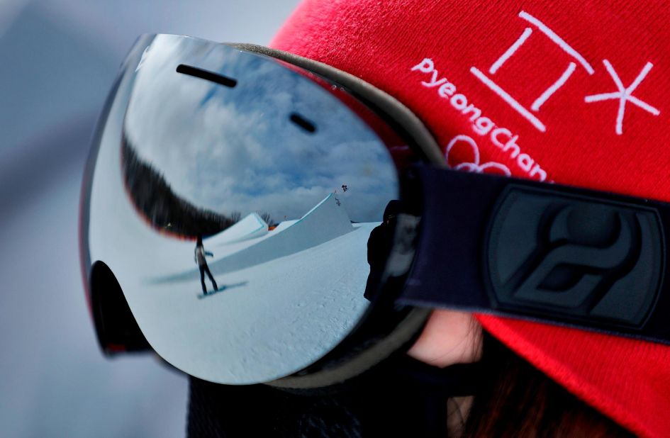 A volunteer watches as athletes run the course during a training session prior to the women's slopestyle qualifying. 
