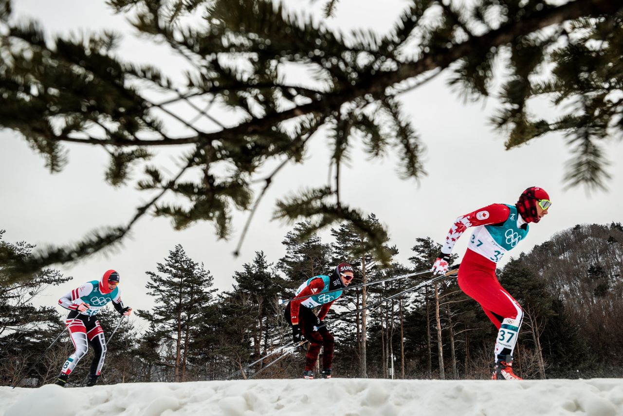 Cross-country skiers compete in the men's 15km + 15km skiathlon race.