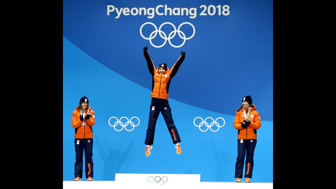 Gold medallist Carlijn Achtereekte of the Netherlands, center, celebrates on the podium with silver medalist Ireen Wust  and bronze medalist Antoinette de Jong during the ceremony for the woman's speed skating 3000m.