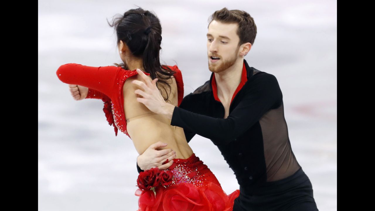 Alexander Gamelin attempts to fix the outfit of partner Yura Min during their ice dance performance. 