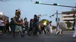 NEW ORLEANS, LA - AUGUST 29: People walk through the streets with a band during a second line parade marking the 10th anniversary of Hurricane Katrina  on August 29, 2015 in New Orleans, Louisiana. Hurricane Katrina killed at least 1836 people and is considered the costliest natural disaster in U.S. history.  (Photo by Joe Raedle/Getty Images)